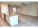 Open living space with tile flooring, seamlessly connecting the kitchen and living areas at 7974 Penrose Pl, Wildwood, FL 34785