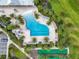 Overhead view of a pristine pool, surrounded by lounge chairs and palm trees, next to a bocce ball court at 7974 Penrose Pl, Wildwood, FL 34785