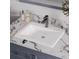 Bathroom vanity featuring a white sink basin, chrome faucet, and elegant marble countertop at 808 Chamberlain Loop, Lake Wales, FL 33853