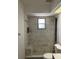 White marble tiled shower featuring a shower bench and window for natural light at 808 Chamberlain Loop, Lake Wales, FL 33853