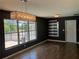 Dining area with wood floors, modern light fixture, and sliding glass doors to screened porch at 808 Chamberlain Loop, Lake Wales, FL 33853