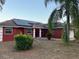 Home exterior with solar panels, freshly painted, and manicured front yard at 808 Chamberlain Loop, Lake Wales, FL 33853