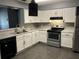 Modern kitchen featuring white cabinets, stainless steel appliances, and subway tile backsplash at 808 Chamberlain Loop, Lake Wales, FL 33853