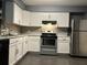 Modern kitchen featuring white cabinets, stainless steel appliances, and subway tile backsplash at 808 Chamberlain Loop, Lake Wales, FL 33853