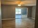 Spacious living room with wood-look flooring, neutral paint, and lots of natural light at 808 Chamberlain Loop, Lake Wales, FL 33853