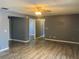 Spacious living room with wood-look flooring and neutral gray paint at 808 Chamberlain Loop, Lake Wales, FL 33853