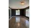 Spacious room with decorative ceiling light and hard wood floors at 808 Chamberlain Loop, Lake Wales, FL 33853