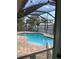 Screened in pool area featuring a shed and brick patio at 808 Chamberlain Loop, Lake Wales, FL 33853