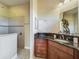 Bathroom showcasing a walk-in shower with glass doors and granite countertops at 8387 Bridgeport Bay Cir, Mount Dora, FL 32757