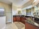 Bathroom featuring double sinks, granite counters, wood cabinetry, and glass walk-in shower at 8387 Bridgeport Bay Cir, Mount Dora, FL 32757
