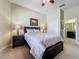 Cozy bedroom features neutral walls, carpet flooring, ensuite bathroom and closet access at 8387 Bridgeport Bay Cir, Mount Dora, FL 32757