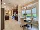Bright dining area with large windows, pendant lighting, and table with upholstered chairs at 8387 Bridgeport Bay Cir, Mount Dora, FL 32757