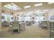 Bright and spacious dining room features multiple tables, stylish chairs, and large windows for natural light at 8387 Bridgeport Bay Cir, Mount Dora, FL 32757