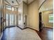 Spacious foyer with a decorative front door, high ceilings, and tile flooring at 8387 Bridgeport Bay Cir, Mount Dora, FL 32757