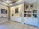 Hallway features custom built-ins, shelving, stylish decor, and elegant architectural details at 8387 Bridgeport Bay Cir, Mount Dora, FL 32757