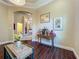 Hallway featuring wood floors, decorative table with flowers, and connecting archway to other rooms at 8387 Bridgeport Bay Cir, Mount Dora, FL 32757
