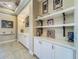 Hallway features custom built-ins, shelving, stylish decor, and elegant architectural details at 8387 Bridgeport Bay Cir, Mount Dora, FL 32757
