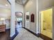 Hallway showcasing tile flooring, open archway leading to living spaces, and access to laundry and bathroom at 8387 Bridgeport Bay Cir, Mount Dora, FL 32757