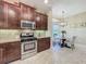 Well-equipped kitchen features stainless steel appliances, granite counters, and tile backsplash at 8387 Bridgeport Bay Cir, Mount Dora, FL 32757