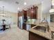 Spacious kitchen features stainless steel appliances, granite counters, and breakfast nook at 8387 Bridgeport Bay Cir, Mount Dora, FL 32757