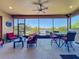 Relaxing screened lanai boasting a tranquil lake view and comfortable seating at 8387 Bridgeport Bay Cir, Mount Dora, FL 32757