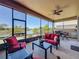 Outdoor lanai area features stylish furniture, ceiling fan, and serene water views at 8387 Bridgeport Bay Cir, Mount Dora, FL 32757