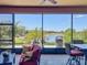 Beautiful water view from a screened lanai with ample space to sit and dine at 8387 Bridgeport Bay Cir, Mount Dora, FL 32757