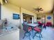 Covered lanai with outdoor kitchen, dining, and lounge area for entertaining guests at 8387 Bridgeport Bay Cir, Mount Dora, FL 32757