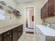 Well-organized laundry room with appliances, countertops, and hanging rack, plus lots of storage space at 8387 Bridgeport Bay Cir, Mount Dora, FL 32757