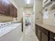 Spacious laundry room with tile flooring, a washer and dryer, and granite countertops at 8387 Bridgeport Bay Cir, Mount Dora, FL 32757