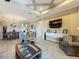 Bright living room features a coffered ceiling, neutral walls and cozy seating area at 8387 Bridgeport Bay Cir, Mount Dora, FL 32757