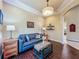Inviting living room with wood flooring, a comfortable couch, and decorative furniture with natural lighting at 8387 Bridgeport Bay Cir, Mount Dora, FL 32757