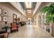 The elegant lobby features comfortable seating, decorative art, and a well-lit hallway with tiled floors at 8387 Bridgeport Bay Cir, Mount Dora, FL 32757