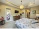 Spacious main bedroom with a TV, dresser, and access to the outdoor patio at 8387 Bridgeport Bay Cir, Mount Dora, FL 32757