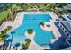 Aerial view of a stunning community pool area, complete with a hot tub and lounge chairs at 8387 Bridgeport Bay Cir, Mount Dora, FL 32757
