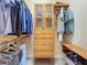Bright and spacious walk-in closet with custom wood shelving and organizers at 8387 Bridgeport Bay Cir, Mount Dora, FL 32757
