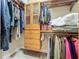 Bright walk-in closet featuring custom shelving and hanging clothes at 8387 Bridgeport Bay Cir, Mount Dora, FL 32757