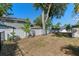 A well-maintained backyard with a white fence, mature trees, and a peaceful spot for relaxing and enjoying the outdoors at 903 Belle Oak Dr, Leesburg, FL 34748