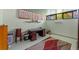 Office area in basement with large desk, tiled floors, and natural light from egress windows at 903 Belle Oak Dr, Leesburg, FL 34748