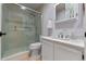 Bathroom with tile flooring and a glass shower enclosure, vanity sink, and custom cabinets at 903 Belle Oak Dr, Leesburg, FL 34748