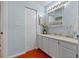 Bright bathroom featuring tile floors, a vanity with sink, and ample cabinet storage at 903 Belle Oak Dr, Leesburg, FL 34748