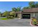 Charming townhome featuring an attached garage, landscaped yard, and black accents at 903 Belle Oak Dr, Leesburg, FL 34748
