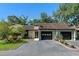 Charming townhome featuring an attached garage, landscaped yard, and black accents at 903 Belle Oak Dr, Leesburg, FL 34748