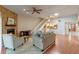 Cozy living room with a stone fireplace, hardwood floors, and a ceiling fan at 903 Belle Oak Dr, Leesburg, FL 34748