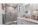 Beautiful bathroom with glass shower, modern fixtures, and bright vanity with makeup mirror at 9134 Mossy Oak Ln, Clermont, FL 34711