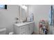 Clean and bright bathroom with white vanity, marble countertop, and storage shelves at 9134 Mossy Oak Ln, Clermont, FL 34711