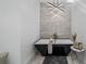 Modern bathroom featuring a freestanding tub, unique lighting, and contemporary design at 9134 Mossy Oak Ln, Clermont, FL 34711