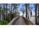 Boardwalk stretching over water with Spanish moss draped trees at 9134 Mossy Oak Ln, Clermont, FL 34711