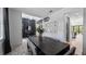 Dining room featuring a dark wood table with gray chairs, unique lighting, and elegant decor at 9134 Mossy Oak Ln, Clermont, FL 34711