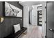 Welcoming entryway with modern decor, textured walls, stylish bench and a decorative pillow at 9134 Mossy Oak Ln, Clermont, FL 34711